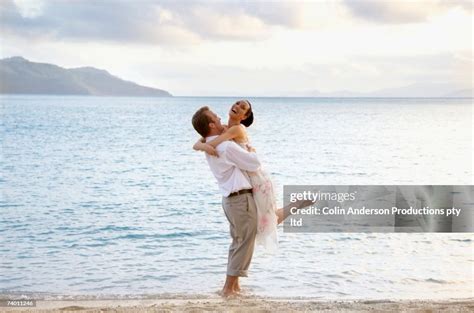 Couple Hugging At Beach High-Res Stock Photo - Getty Images