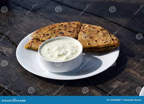 Aloo Paratha and Curd for Breakfast Placed on Wooden Board Stock Image ...