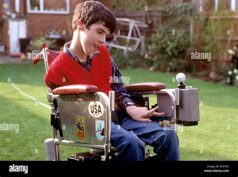 Boy with Cerebral Palsy in his wheel chair at home in the garden Stock ...