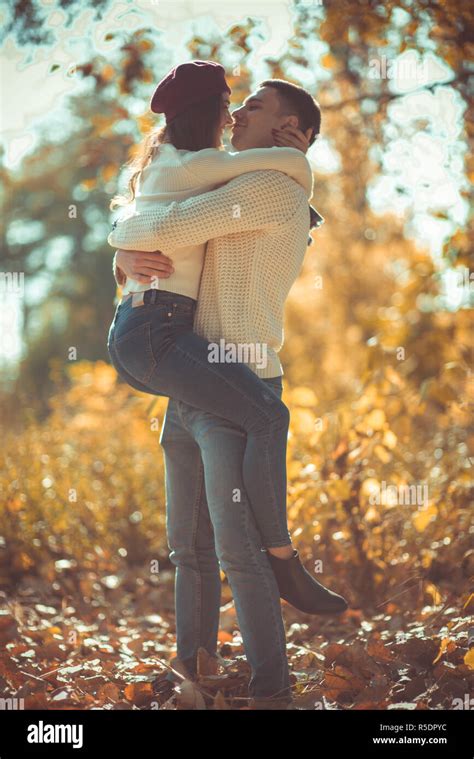 Sweet couple is in the park, hugging and looking very happy, enjoying ...