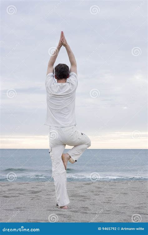 Man doing yoga on beach stock photo. Image of serenity - 9465792