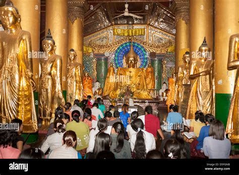 Worshippers praying inside a prayer hall at Shwedagon Pagoda, Yangon ...