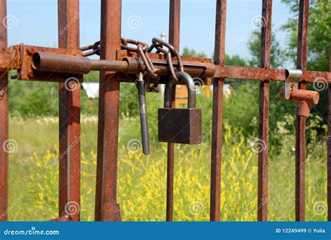 Locked rusty gate stock image. Image of meadow, brown - 12249499