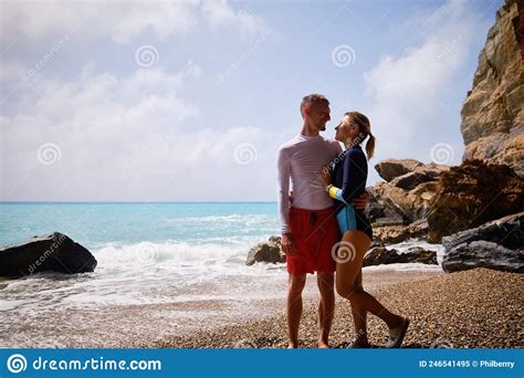 Couple on a beach hugging stock image. Image of lifestyle - 246541495