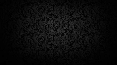 black wallpaper with swirls and scrolls on the bottom, as well as dark ...