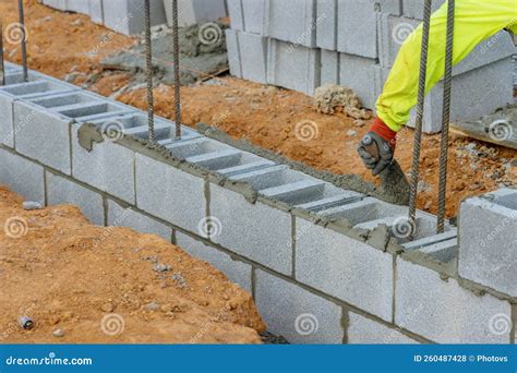 Bricklayers are Laying Concrete Blocks in a Wall in Order To Construct ...