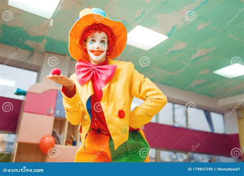 Funny Clown Poses with Red Nose in Hand Stock Photo - Image of ...