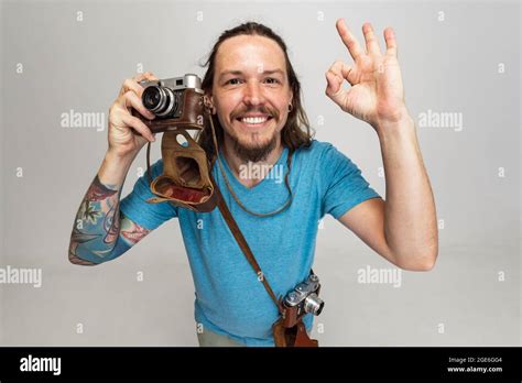 High angle view of young man, photographer, cameraman with retro camera ...