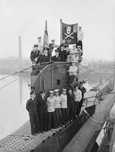 The crew of HM Submarine UNISON display their 'Jolly Roger' at Plymouth ...