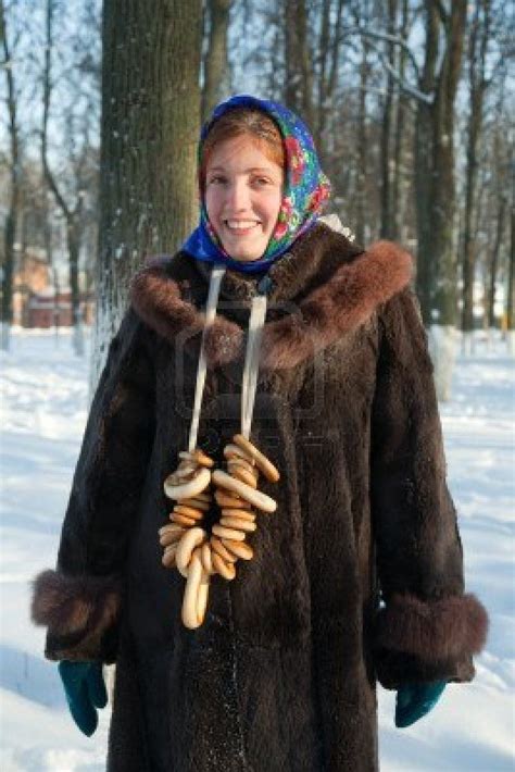 Girl in russian traditional clothes against winter rural landscape