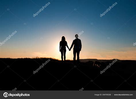 Romantic couple hug at sunset on background. Stock Photo by ...