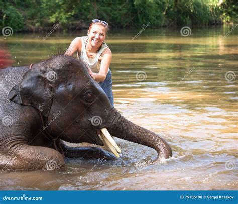 Baby Elephant Bathing in the River, and Next To an Elephant Standing ...