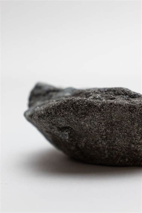 a black rock sitting on top of a white table