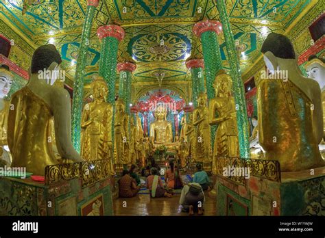 People praying inside the Shwedagon pagoda Stock Photo - Alamy