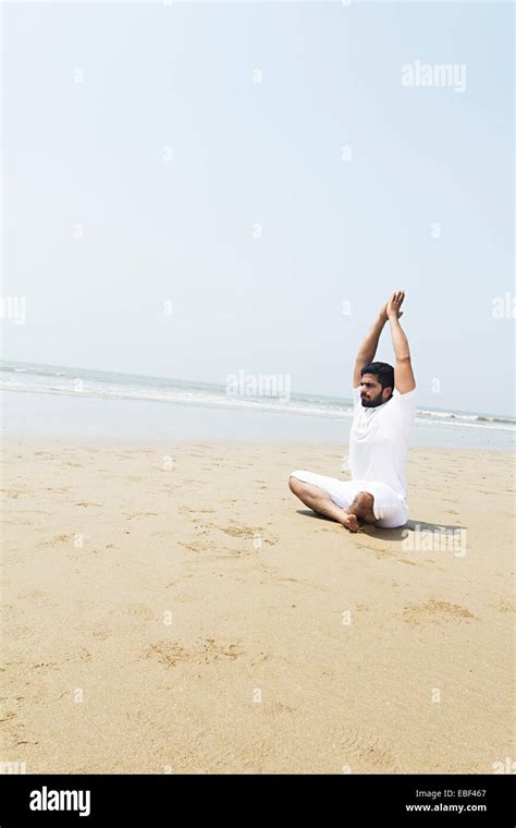 indian man beach Yoga Stock Photo - Alamy