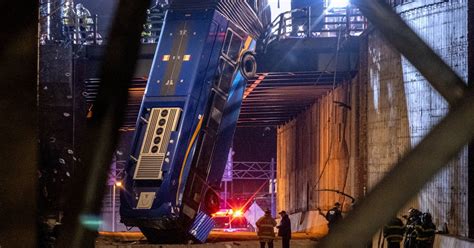 New York City bus left hanging from overpass after crash, injuring 8