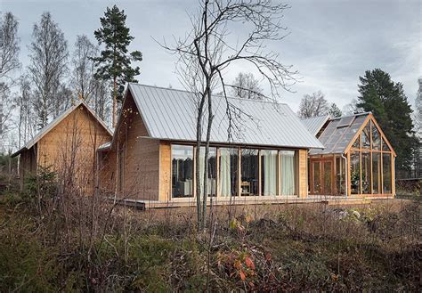 emerging from a swedish forest, fria folket's house is organized around ...