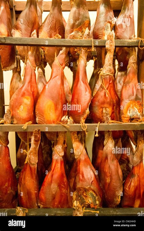 Salt cured hams hanging Stock Photo - Alamy