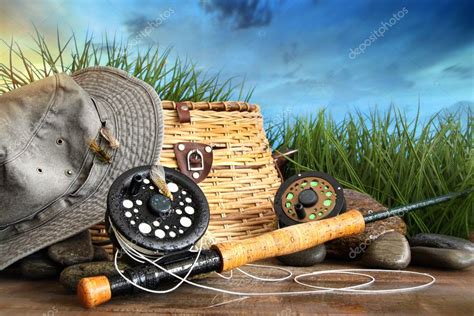 Fly fishing equipment with hat on wooden dock — Stock Photo ...