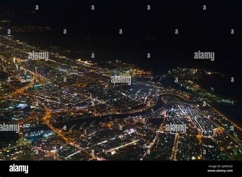 Night view of Dubai Skyline seen from flying plane above Persian Gulf ...