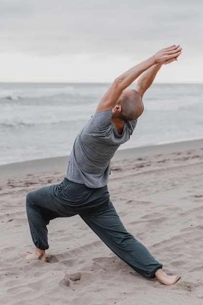 Premium Photo | Man on the beach practicing yoga meditation