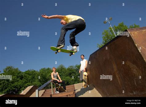 Three skateboarders doing tricks at a skate park Stock Photo - Alamy