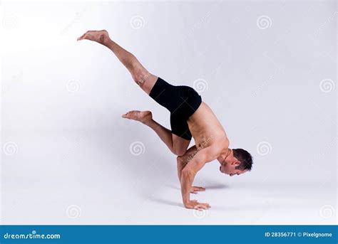 Male Yoga Follower Is Performing Stretching Of Legs Sitting On Floor In ...