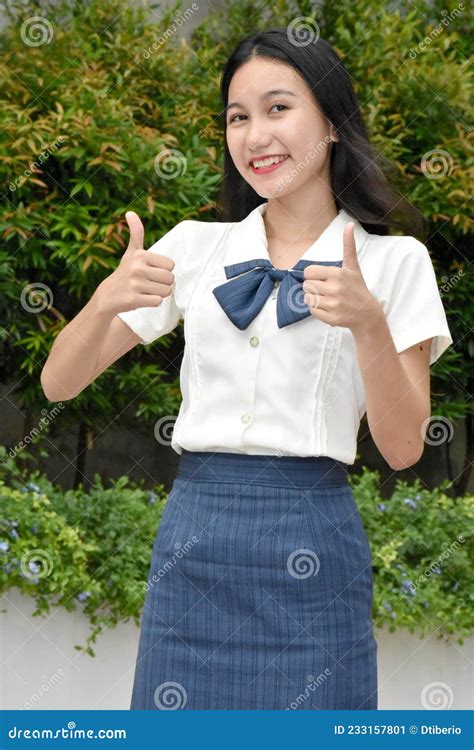 Pretty Female Student with Thumbs Up Wearing School Uniform Standing ...