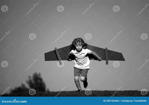 Child Playing with Cardboard Toy Wings in the Park. Concept of Children ...