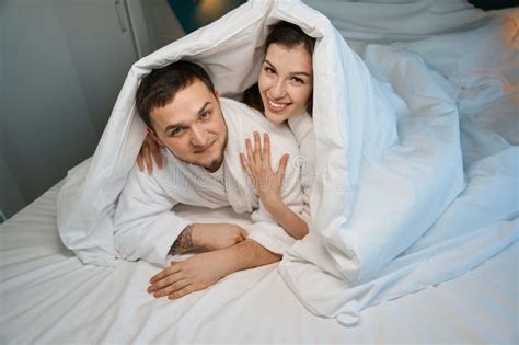 Happy Young Couple Hugging on a Big Bed Stock Photo - Image of cheerful ...