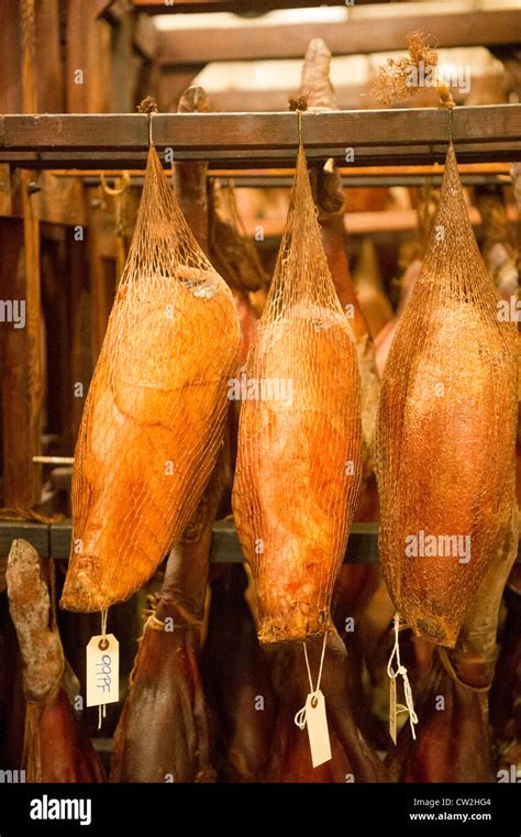 Salt cured hams hanging Stock Photo - Alamy