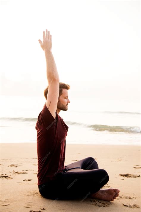 Premium Photo | Man practicing yoga on the beach