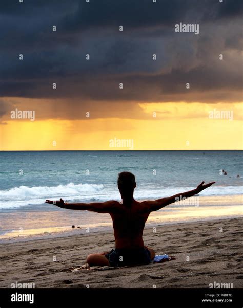 Man doing yoga at beach Stock Photo - Alamy