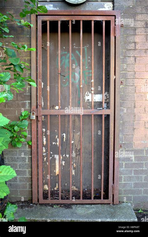 locked bars gate door red rusty grill brick wall Stock Photo - Alamy