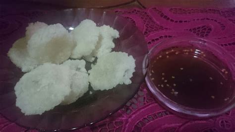 there is a bowl of food and a cup of tea on the doily next to it