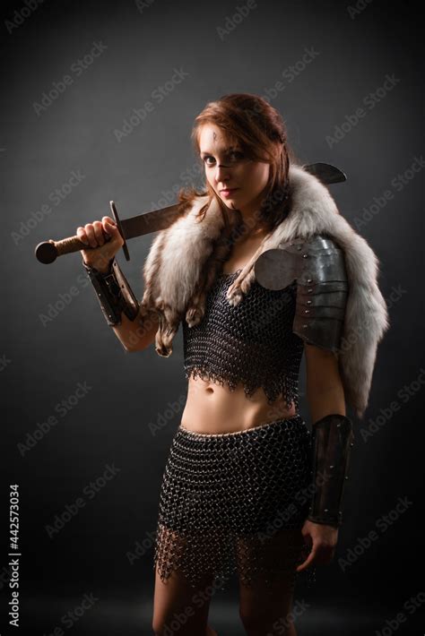 Portrait of a medieval woman warrior in chain mail armor and polar fox ...