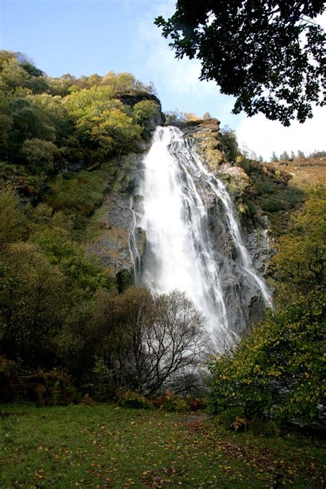 a large waterfall in the middle of a forest