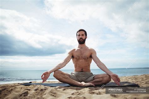 Man performing yoga on beach — nature, calm - Stock Photo | #228958068