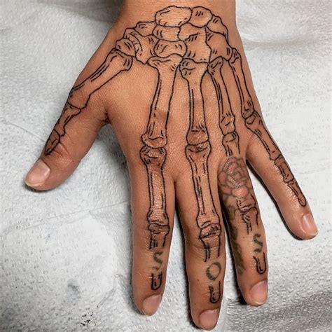 Aggregate 74+ skeleton hand tattoos best - in.cdgdbentre