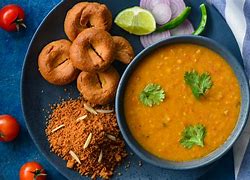 Image result for Rajasthani Dal Bati Churma in Goldan Plat