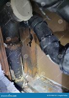 Image result for Cast Iron Pipe in Concrete Block Wall