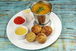 Image result for Rajasthani Dal Bati Churma in Goldan Plat