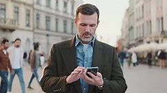 Middle aged man using map app on mobile phone