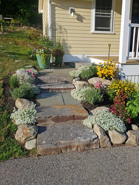 stone steps create an informal approach to farmer&apos;s porch