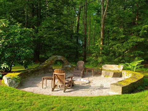 large fit pit area with wood arch built by Gogan Landscaping