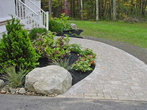 light colored paver stones create front walk to door