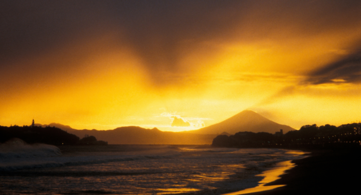 Mount Fuji tosses the sunset into the sky, from Kamakura beach