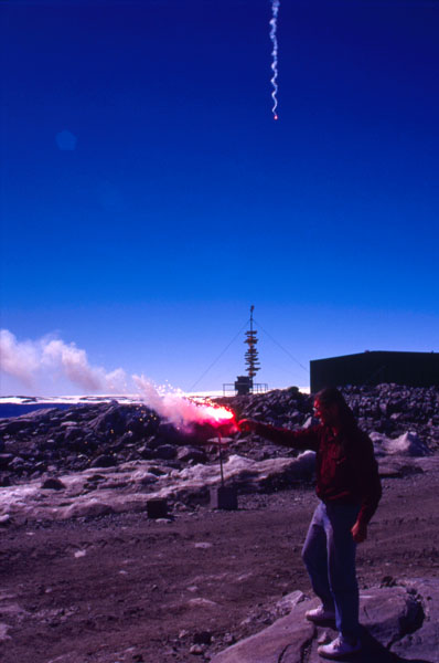 Setting of flares as a Qantas Antarctic flight flies over Casey Station