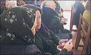 Elderly Portuguese women hold euro cutting in the church