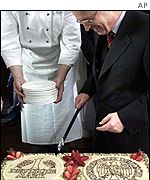 German Finance Minister Hans Eichel  cut a cake with the D-Mark currency emblem 